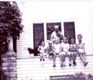 Henry Rogler with fiddle and kids