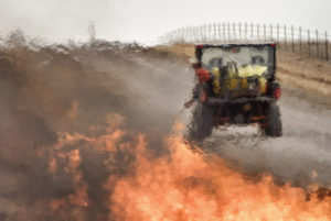 Rancher starting burn from ATV, photographed through heat thermals