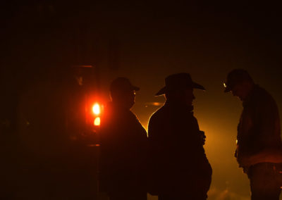 Ranchers visiting on the road during a burn